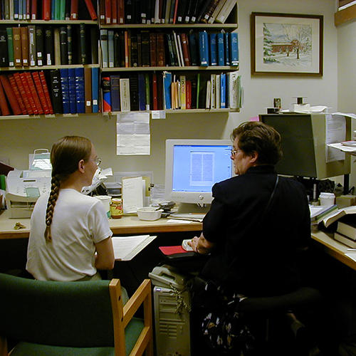 Jennifer Ottman and Rega Wood examining a manuscript image for collation.